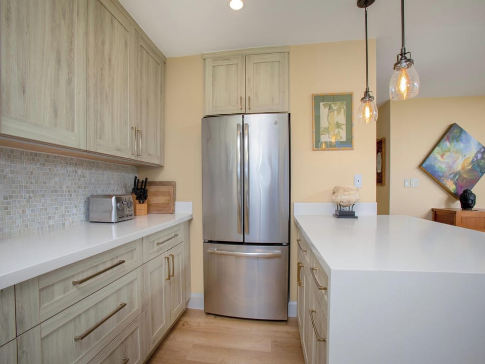 Your fully equipped kitchen features stainless steel appliances, ample counter space, and elegant pendant lighting—perfect for preparing memorable meals during your stay.