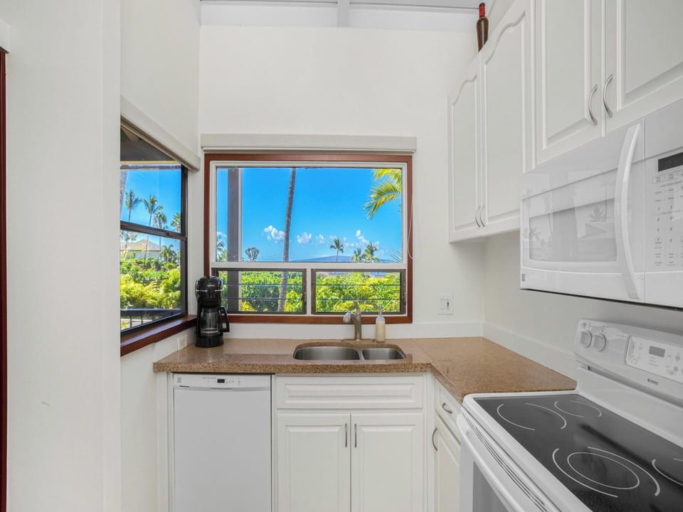A fully equipped kitchen with ocean views — one of the few units in the complex where you can cook with the Pacific in front of you.