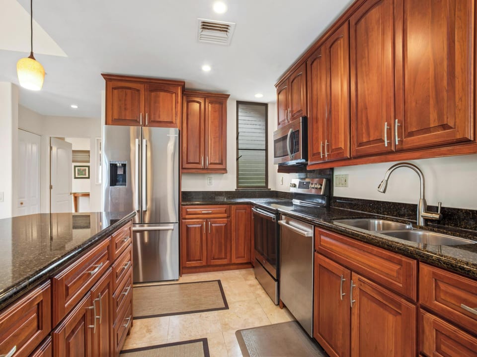 Appliances: Features a refrigerator, oven, microwave, dishwasher, and a coffee maker.