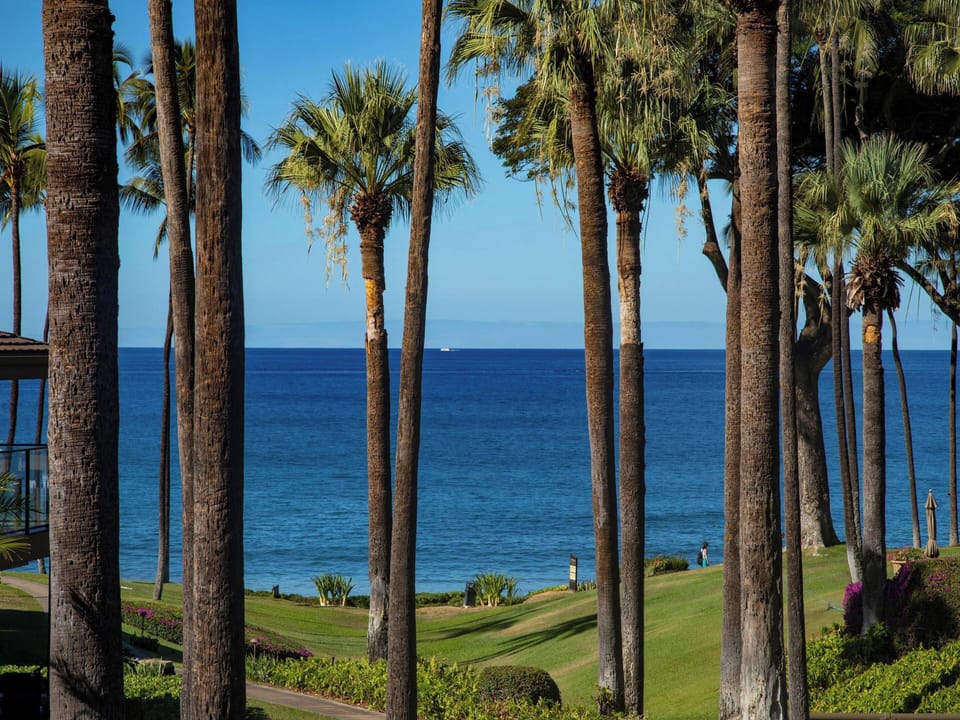 This beautifully remodeled condo sits elevated, opening up sweeping Pacific views from the private balcony.