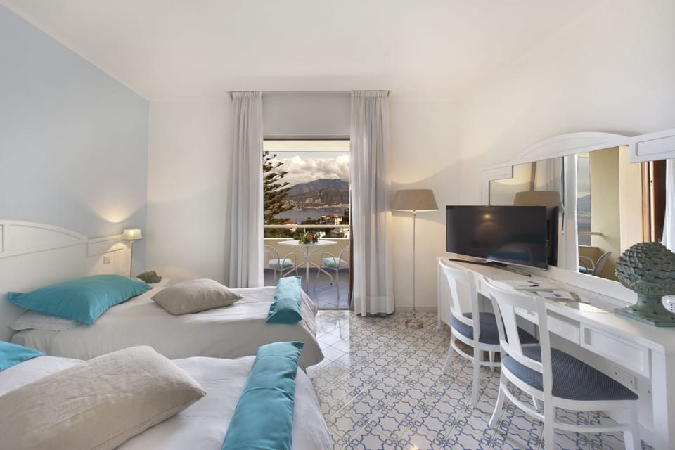 Triple Room, Balcony, Sea View | Minibar, in-room safe, desk, blackout drapes