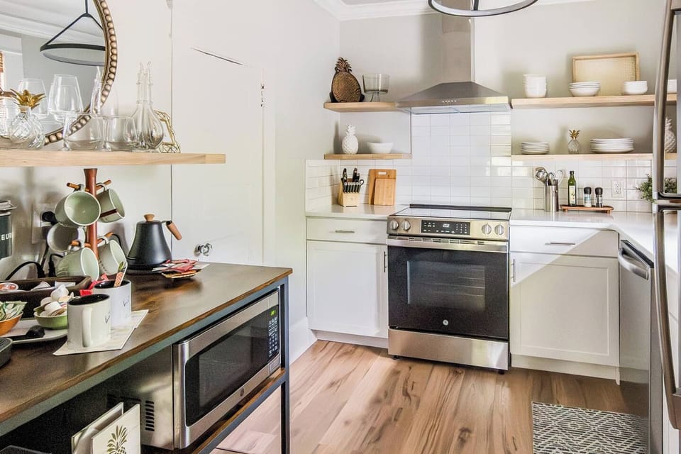 Well-stocked kitchen with stainless fridge, oven/stove, dishwasher, and microwave.