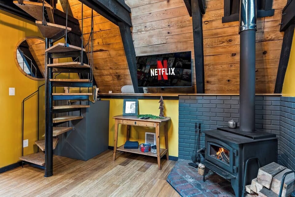 Cozy corner with streaming-ready TV, and the comforting glow of a fireplace. 