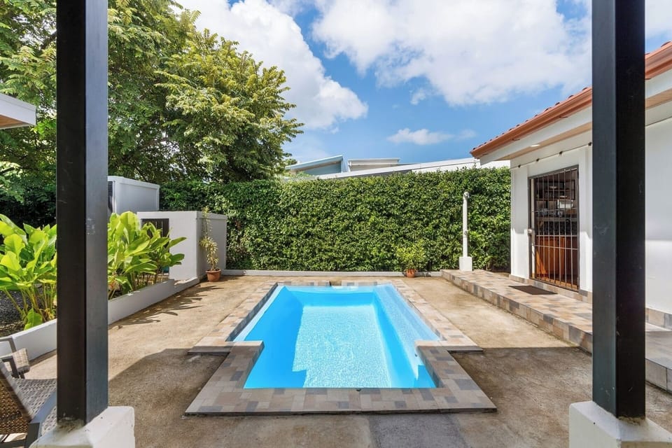 Dive in — private pool surrounded by lush tropical gardens.