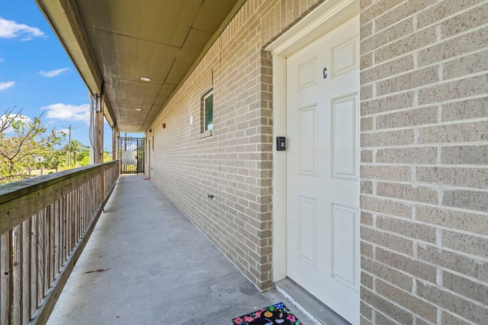 Front door is located above the Exxon gas station; there are stairs on either side of the building.