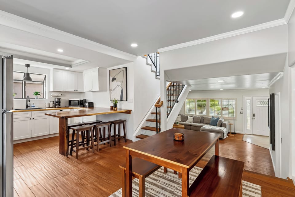 Open dining and kitchen space with wood accents. 
