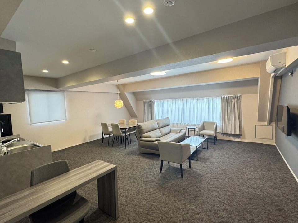 Family Suite | Living area | 27-inch flat-screen TV with cable channels
