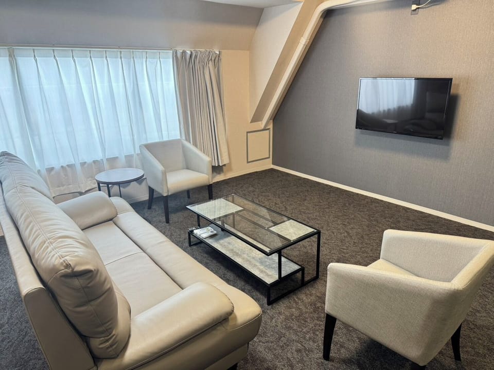Family Suite | Living room | 27-inch flat-screen TV with cable channels