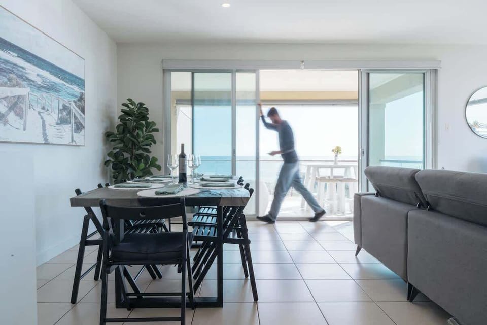 living room and dining room leading to balcony