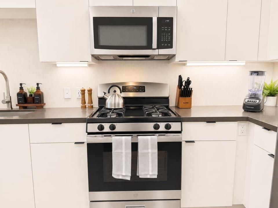 Experience extended comfort with a fully equipped kitchen featuring a coffee machine, stovetop, and microwave—everything you need for a seamless long-term stay.