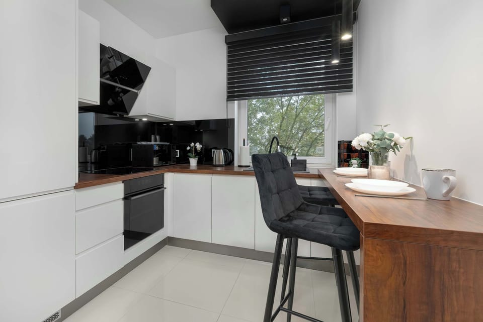 The kitchen's sleek design includes all necessary cookware and utensils.