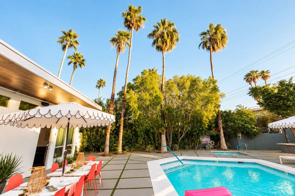 Palm trees, blue skies, and a sparkling pool create an effortless desert-resort escape.