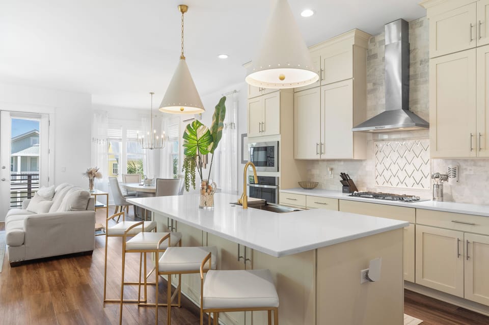 Modern kitchen with pendant lighting and stainless steel appliances.