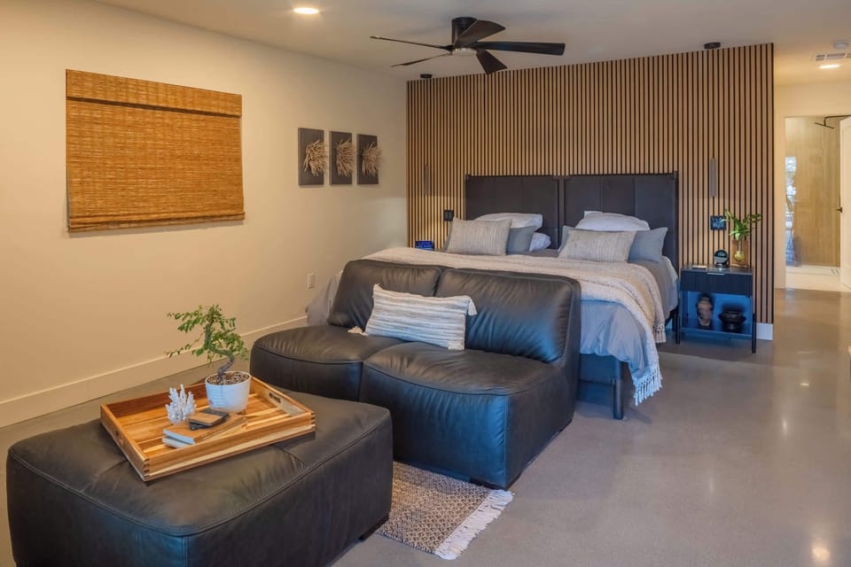 Spacious bedroom with a comfortable bed and cozy seating area