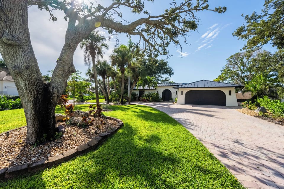 Beautiful front entrance surrounded by lush landscaping