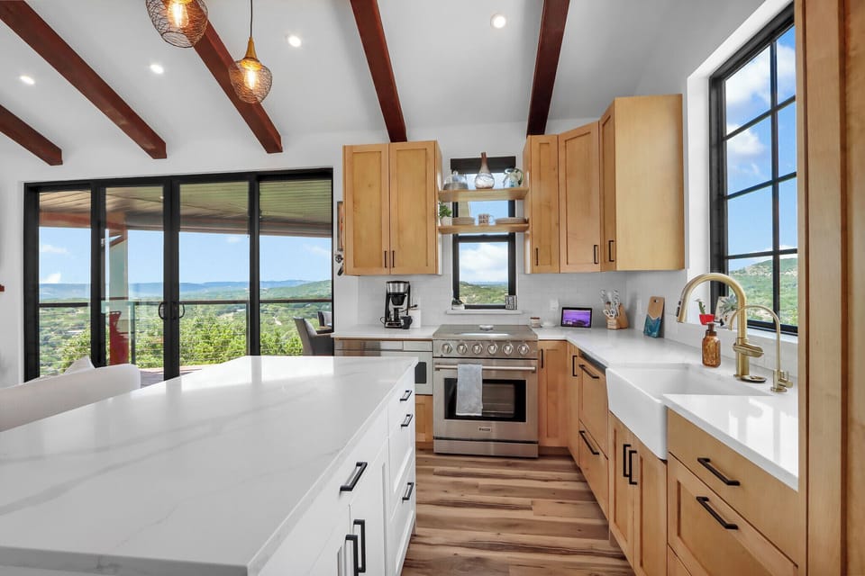 The kitchen is fully stocked with stainless steel appliances