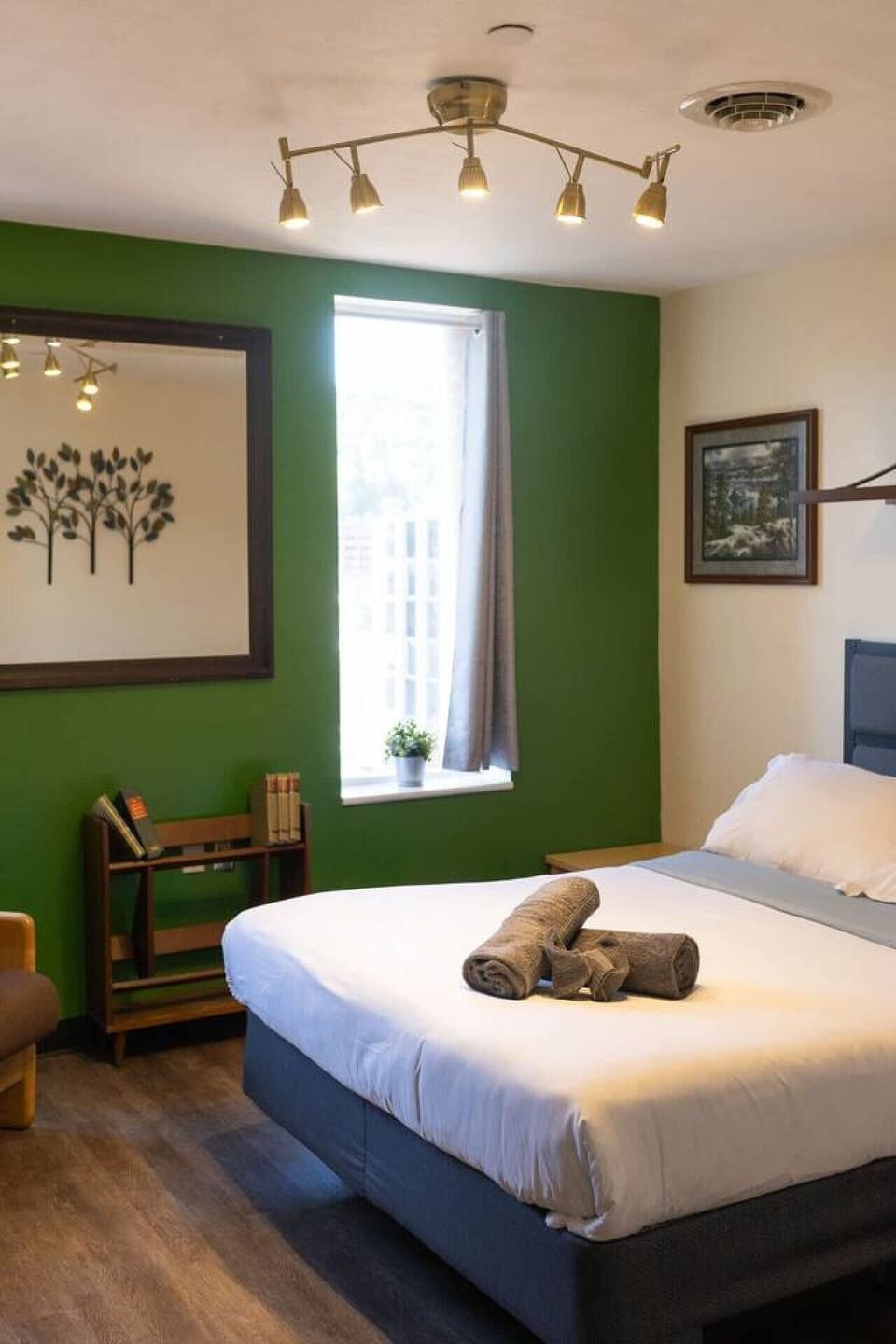 Bright bedroom corner w/ a pop of green & natural light.