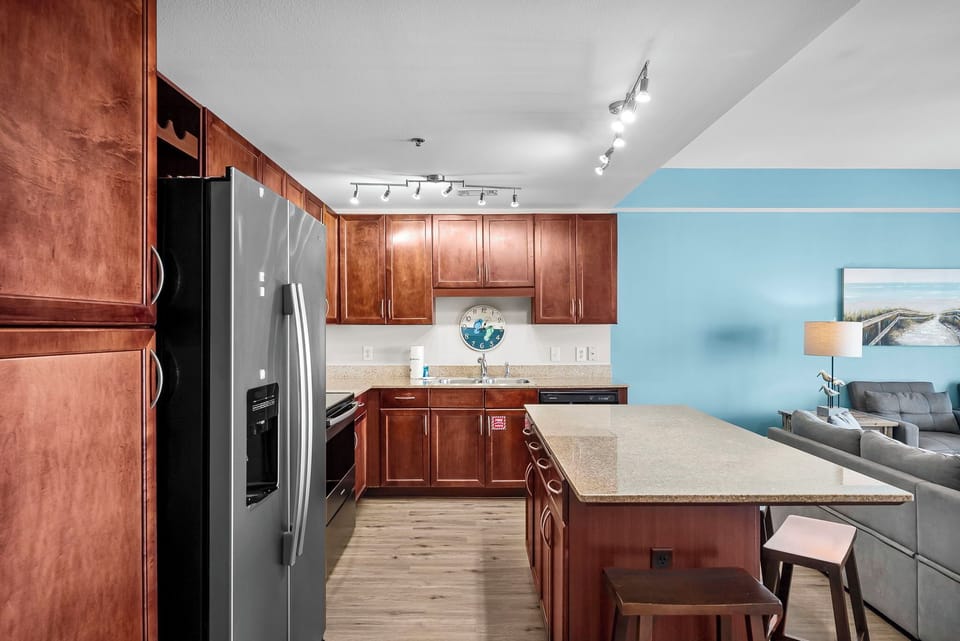 Modern kitchen with granite island and stainless steel appliances