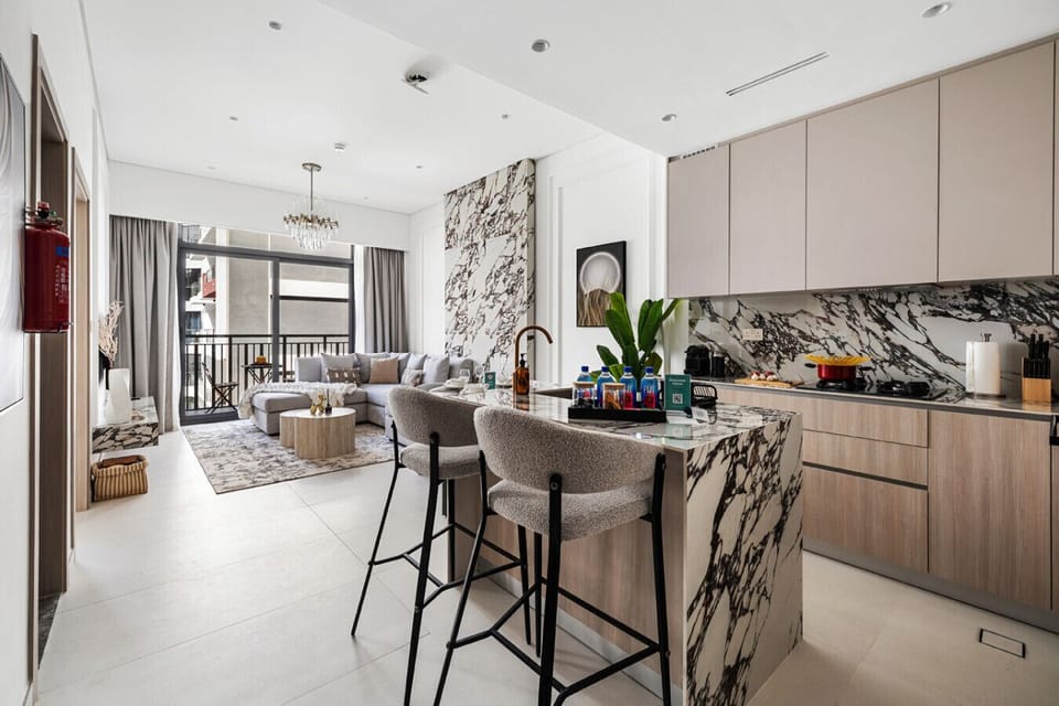 Kitchen area with open living space and balcony access.