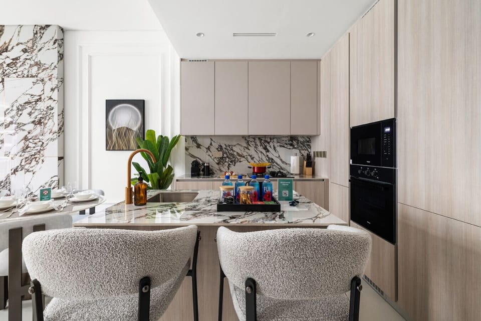 Kitchen area with open living space and balcony access.