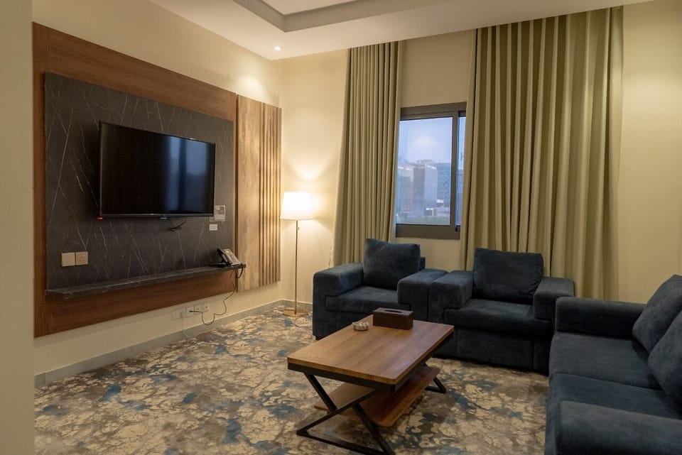 Junior Suite, City View | Living area | TV