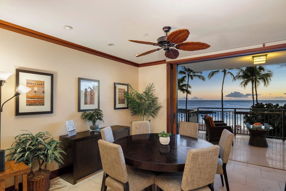Indoor dining framed by floor-to-ceiling ocean views.