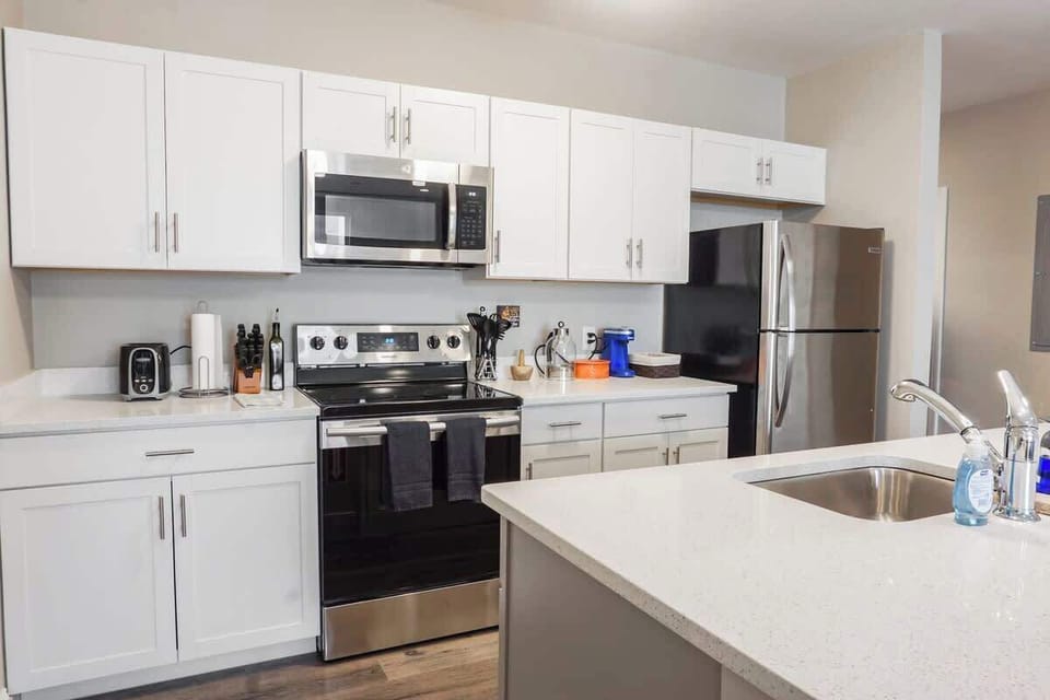 Fully-stocked kitchen with brand-new stainless steel appliances.