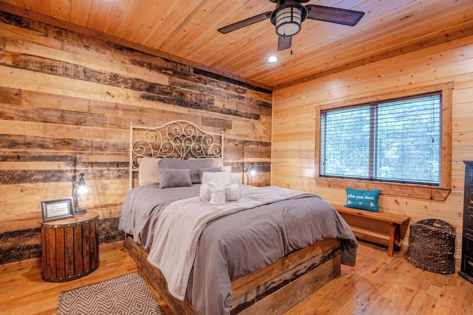A nearly identical bedroom setup, highlighting the comfortable bedding and large windows with natural views. A perfect vacation rental for couples or families.