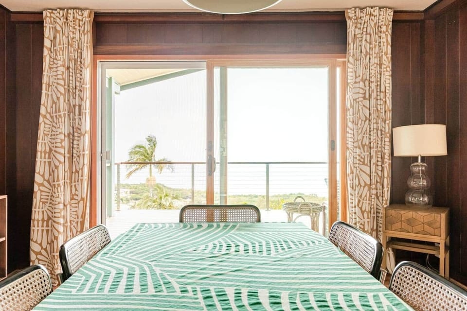 Dining room table view of farm and ocean beyond the lanai