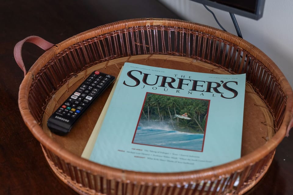 Unwind in your room with a Surfer's Journal and TV remote in this charming wicker basket—perfect for relaxing evenings.