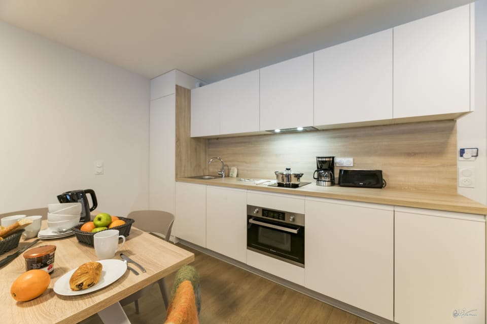 Cook up a delicious breakfast in the modern kitchen, equipped with sleek appliances and ready for family gatherings.