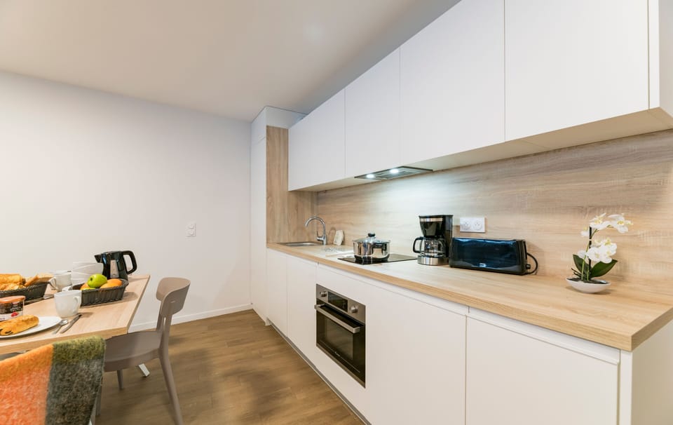 A stylish kitchen equipped with modern amenities awaits, featuring a chic design, perfect for whipping up meals after a day on the slopes.