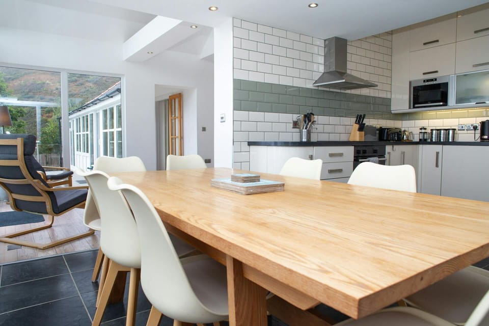 Dining area leading to kitchen with dining table and chairs
