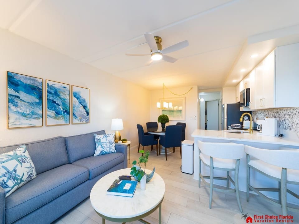 Bright and airy living room with cozy seating and modern kitchen bar!