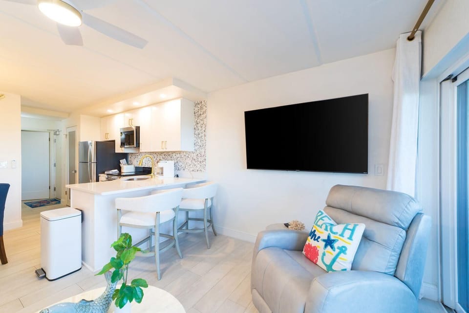 Bright, open kitchen and living area with cozy seating!