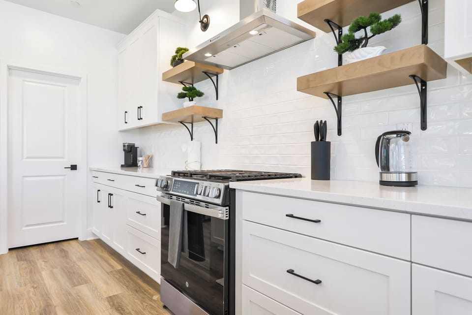 Fully stocked kitchen with cookware, dishes, and essentials.