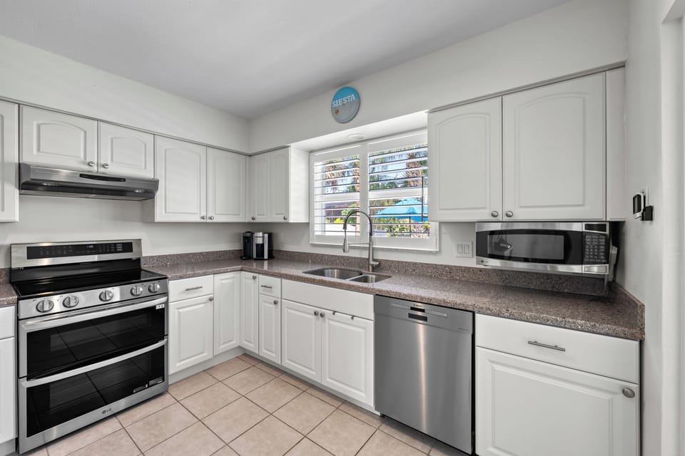 The kitchen is fully stocked with spices, seasonings, and oils. Designed with spacious room for a chef's delight!