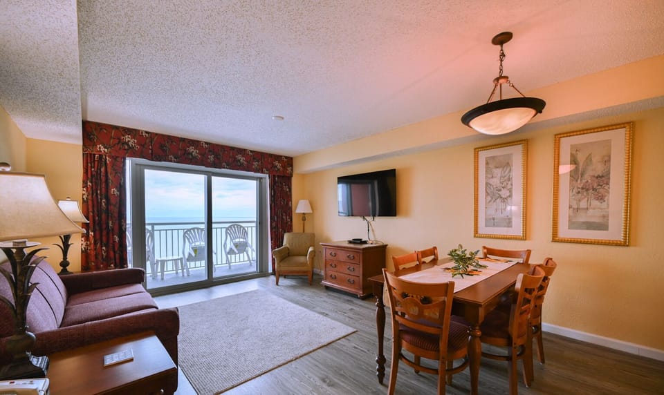 Living room with floor-to-ceiling windows and oceanfront views