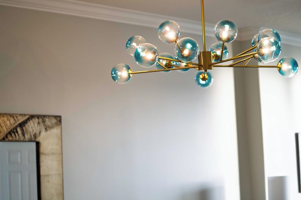 Contemporary chandelier adds warmth and flair to the space