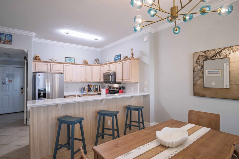 Bright kitchen with breakfast bar, dining space, and modern appliances