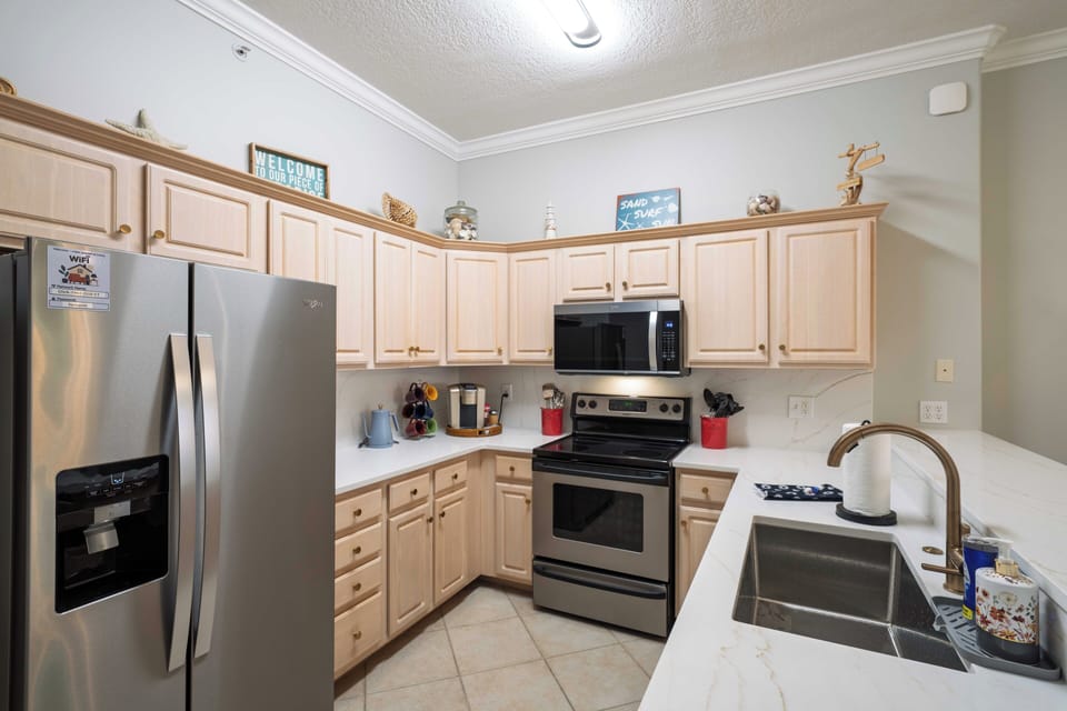 Fully equipped kitchen with stainless steel appliances and ample counter space