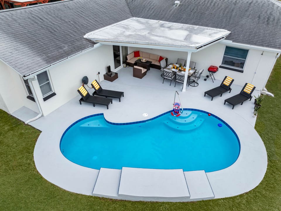 Dine, dip, and dream — this modern outdoor space offers the best of indoor-outdoor living with cozy seating and a refreshing pool.