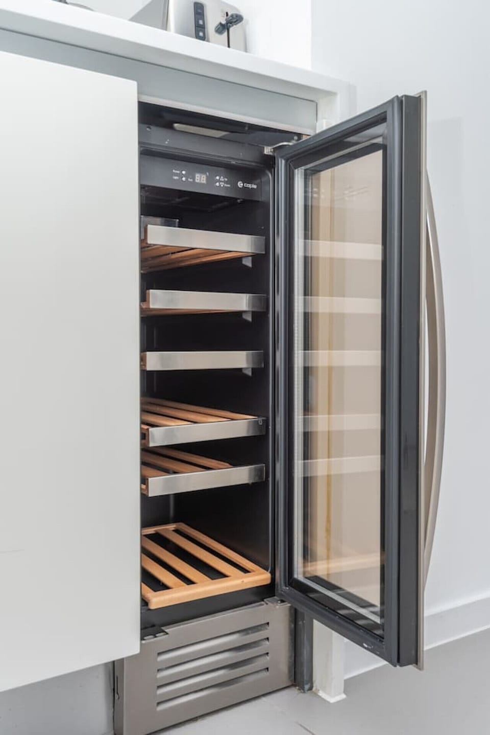 Stocked wine fridge for whenever the mood hits.