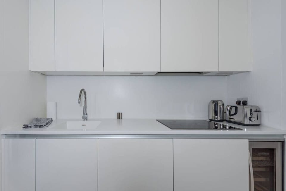 Minimal kitchen with induction hob, kettle, and toaster all ready to go