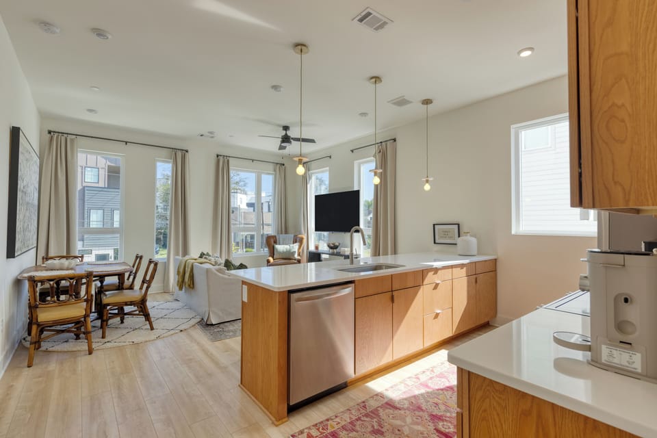 Open layout showcasing kitchen, dining, and living area.