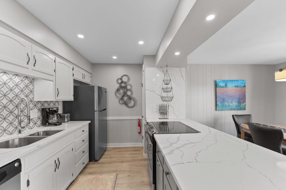 Your fully equipped kitchen features marble countertops, modern appliances, and stylish decor—perfect for preparing memorable meals during your stay.