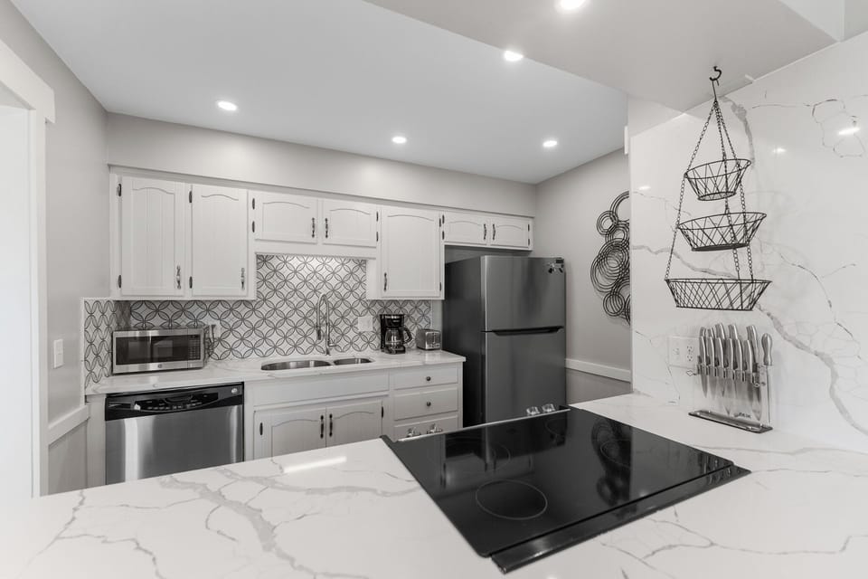 Your modern kitchen features marble countertops, stainless appliances, and elegant finishes for effortless meal preparation during your stay.