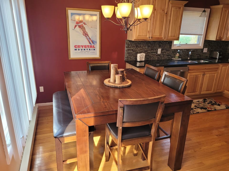 DINING TABLE:   The home has a high-top dining table with seating for up to 6 adults.