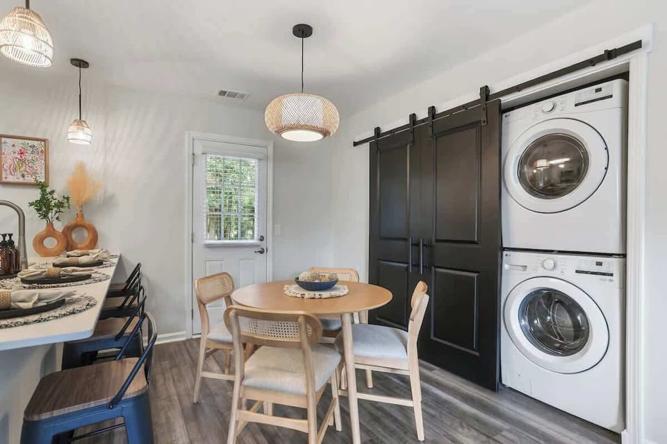 Laundry closet blends seamlessly into the dining space, offering both function and discretion.