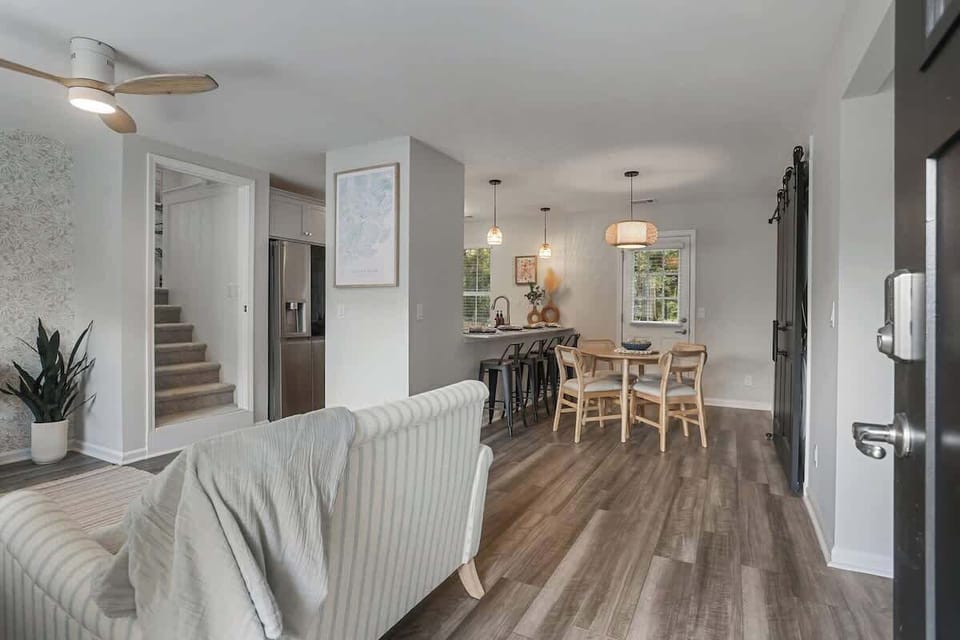 This open floorplan creates a light-filled space where the kitchen, dining, and living areas flow seamlessly together.
